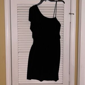 Black jersey dress with asymmetrical shoulder details.